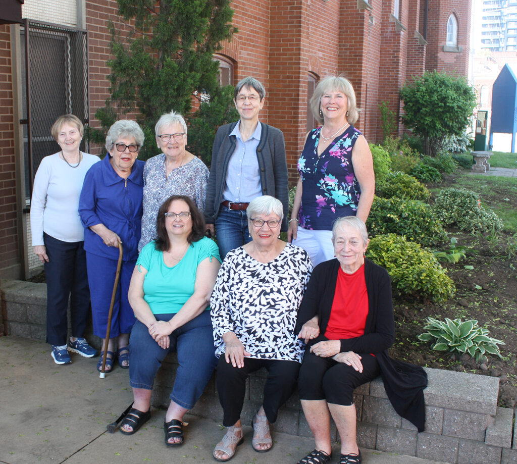 A group of women that belong to the Bibles and Bagels group standing outside in front of Trinity Lutheran Church